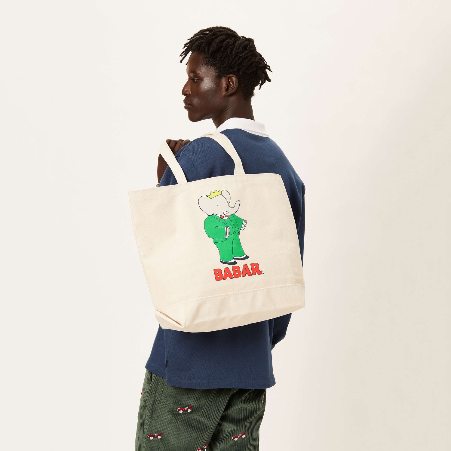 Male model holding the Babar Tote.