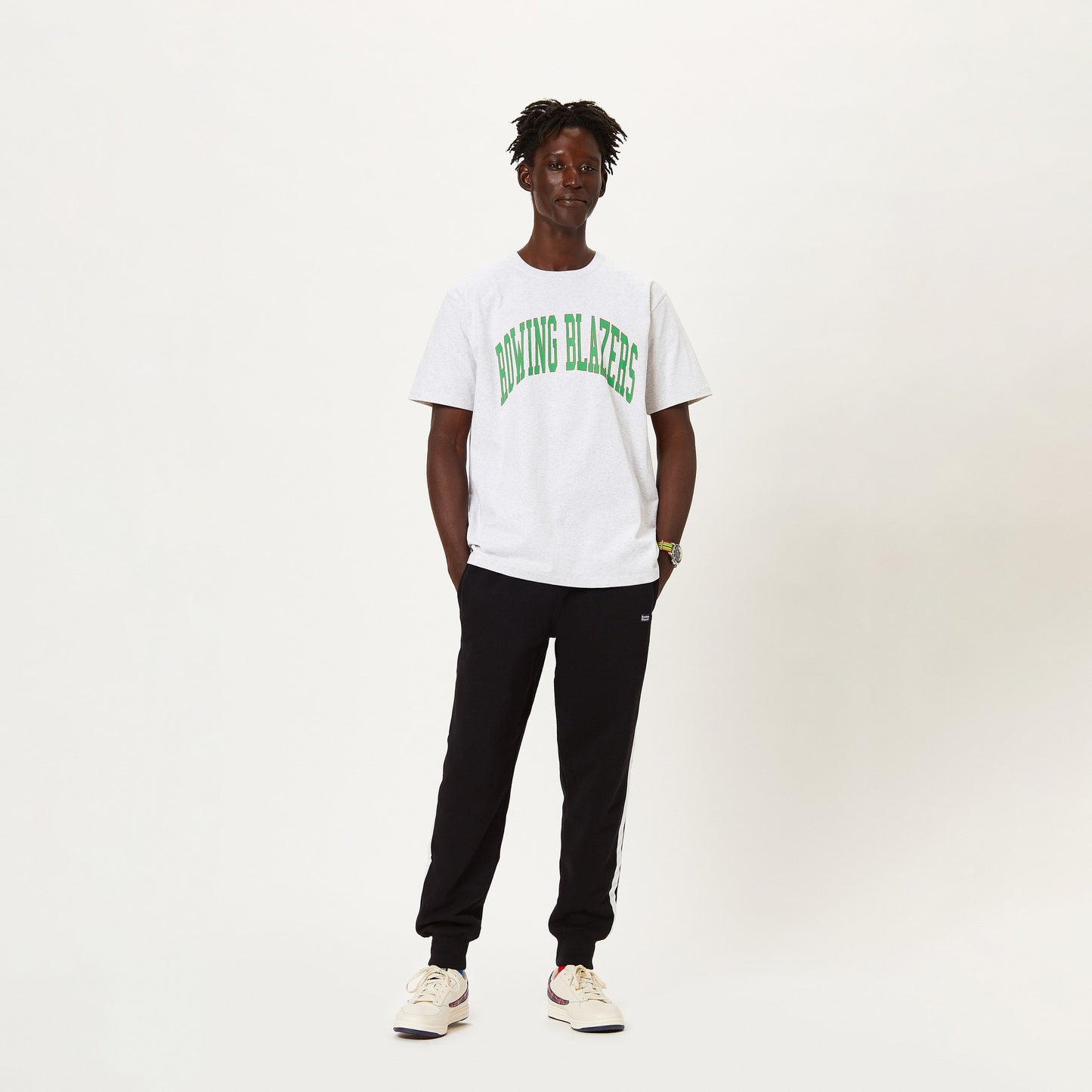 Male model wearing the Rowing Blazers collegiate tee.