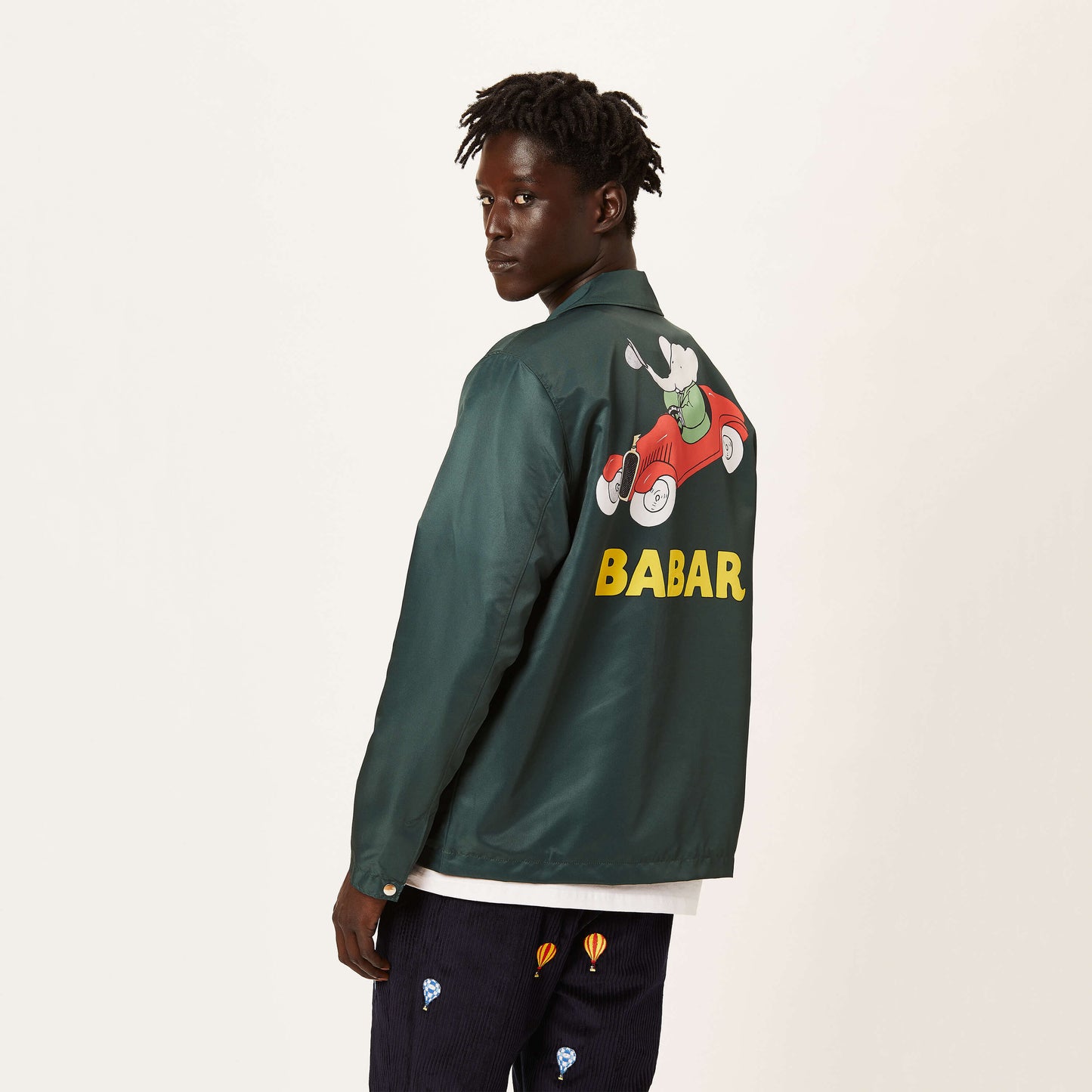 Male model wearing the green Babar Coach's Jacket.