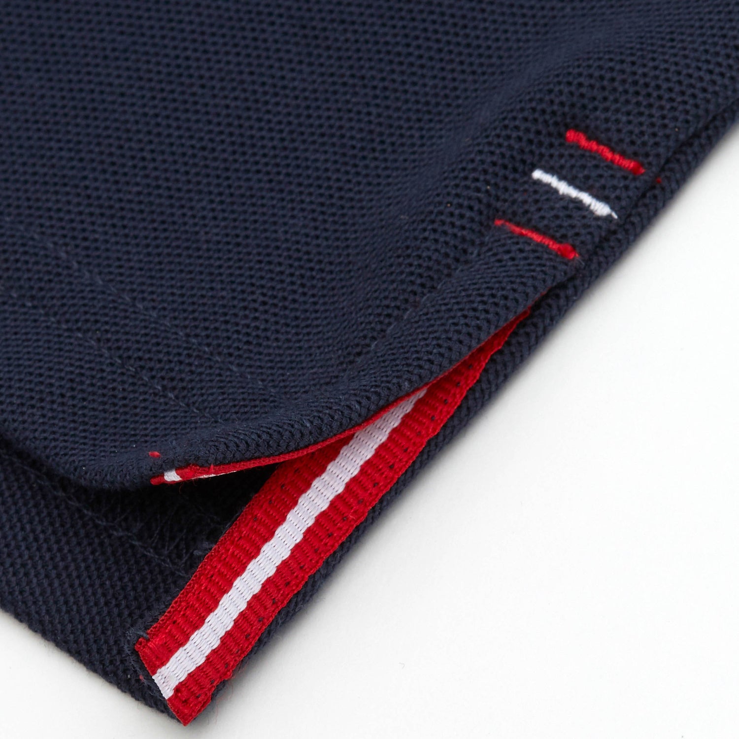 Red and white grosgrain detail on side vent.