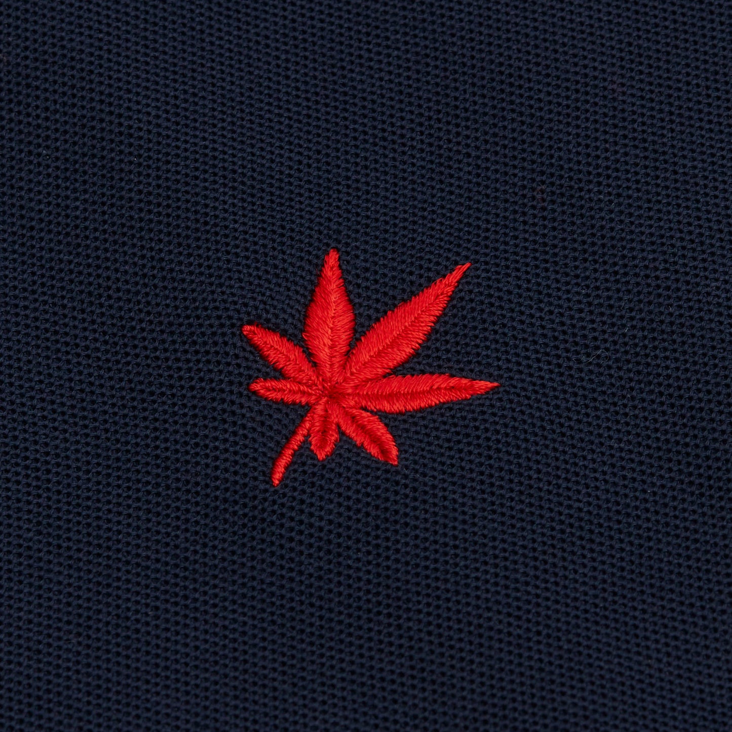 Red embroidered leaf.