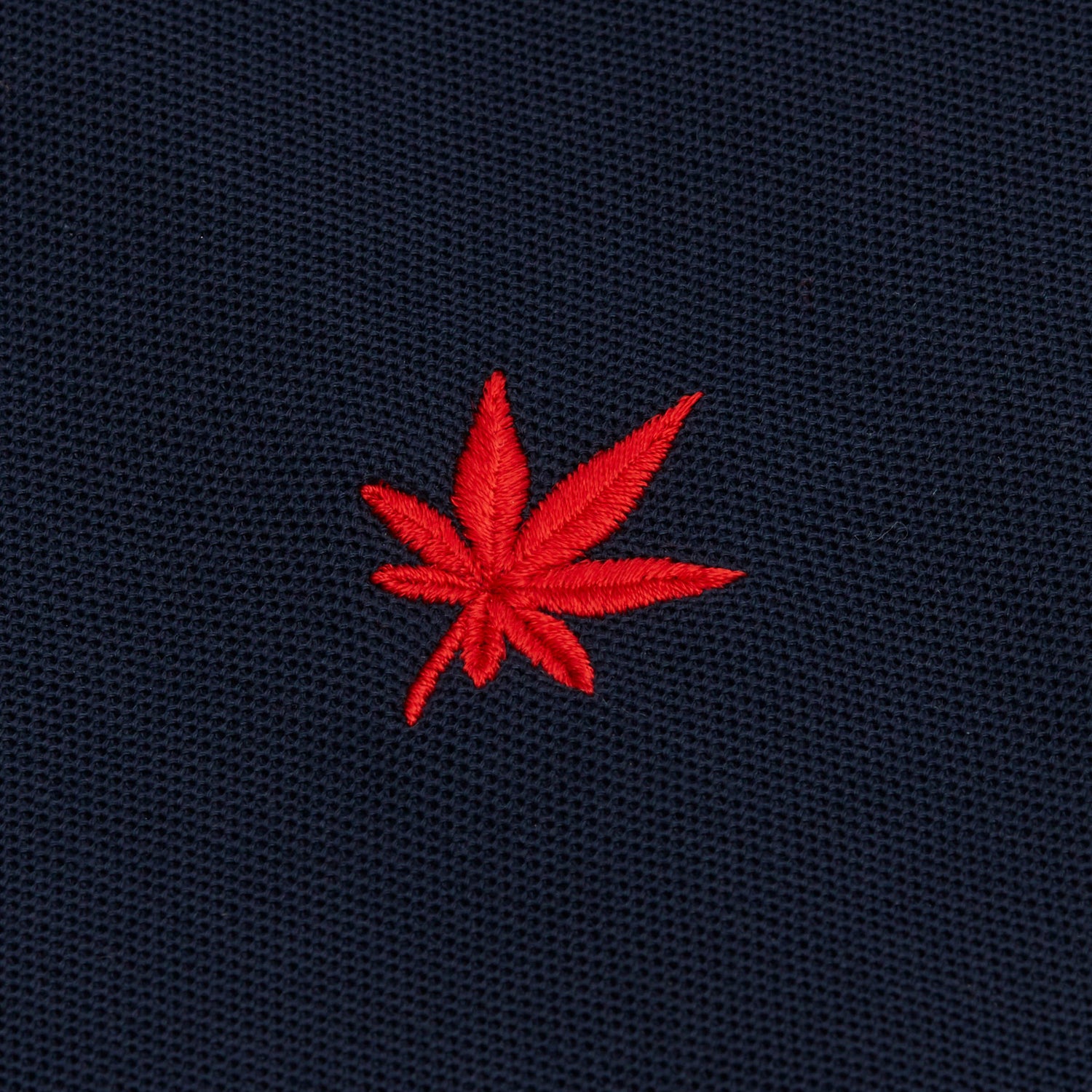 Red embroidered leaf.