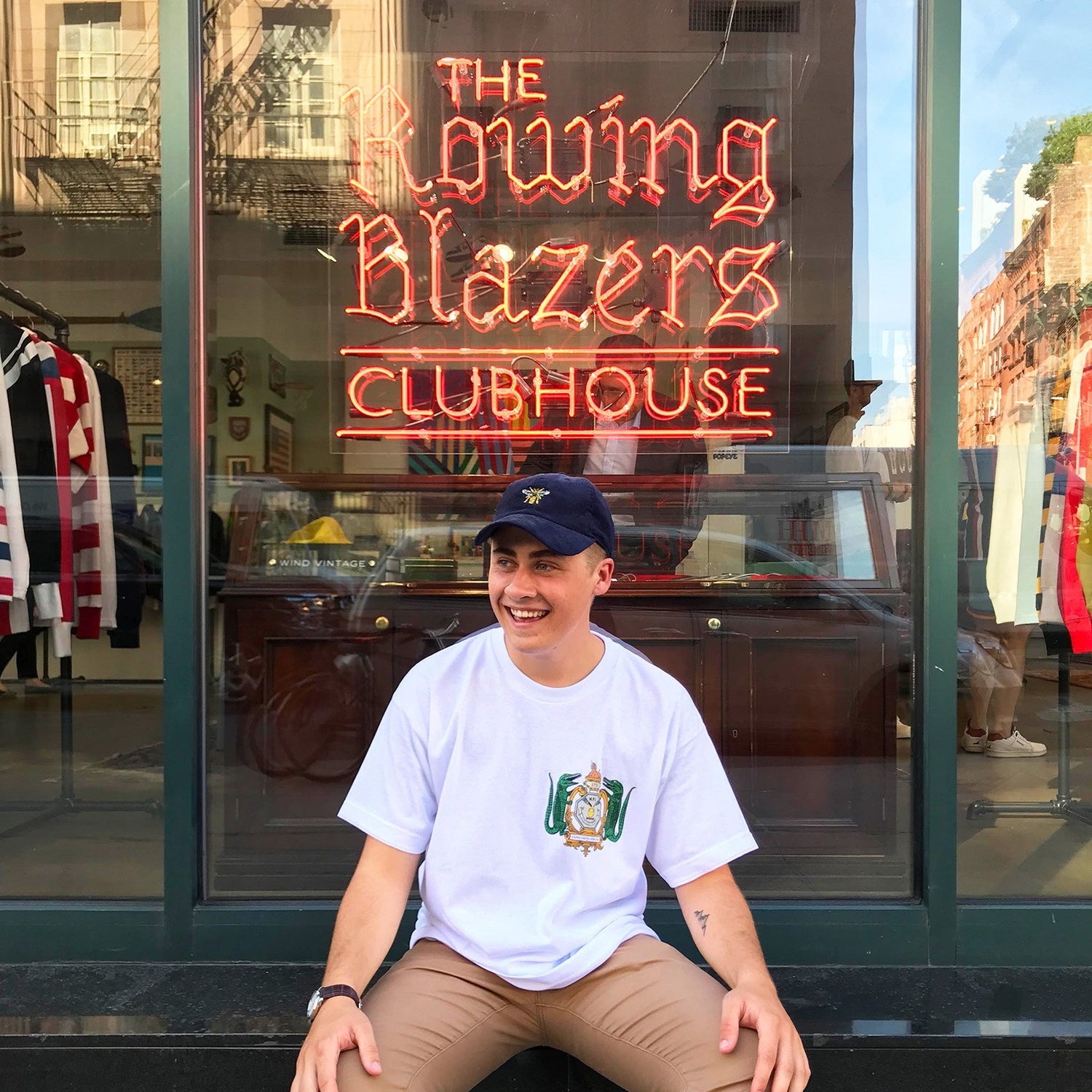 Male model wearing the Navy Drone Cap outside the Rowing Blazers store in downtown New York City.