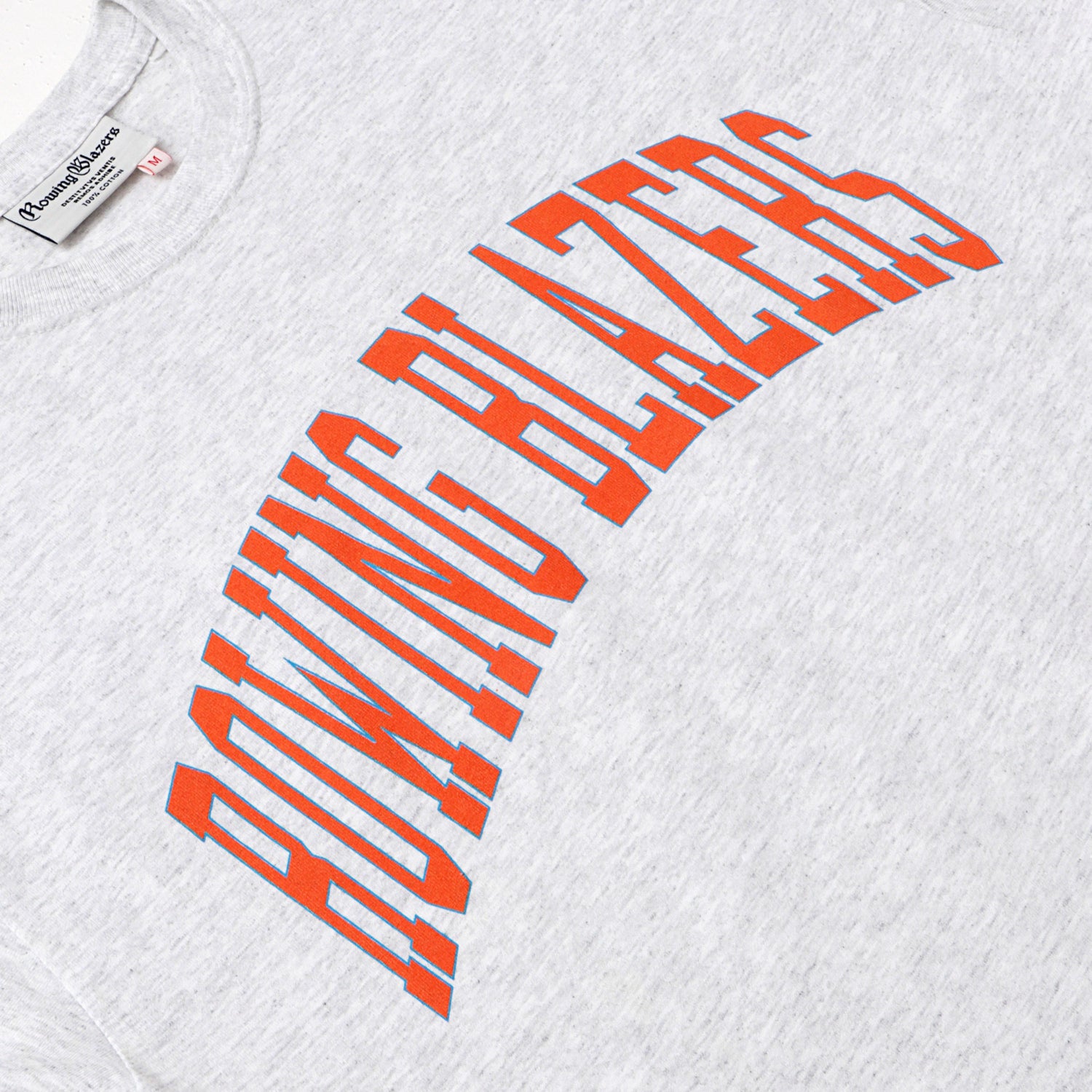 "Rowing Blazers" across the front, collegiate style, in orange.