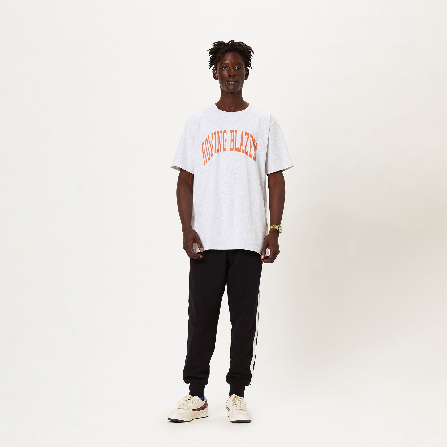 Male model wearing the Rowing Blazers collegiate tee.