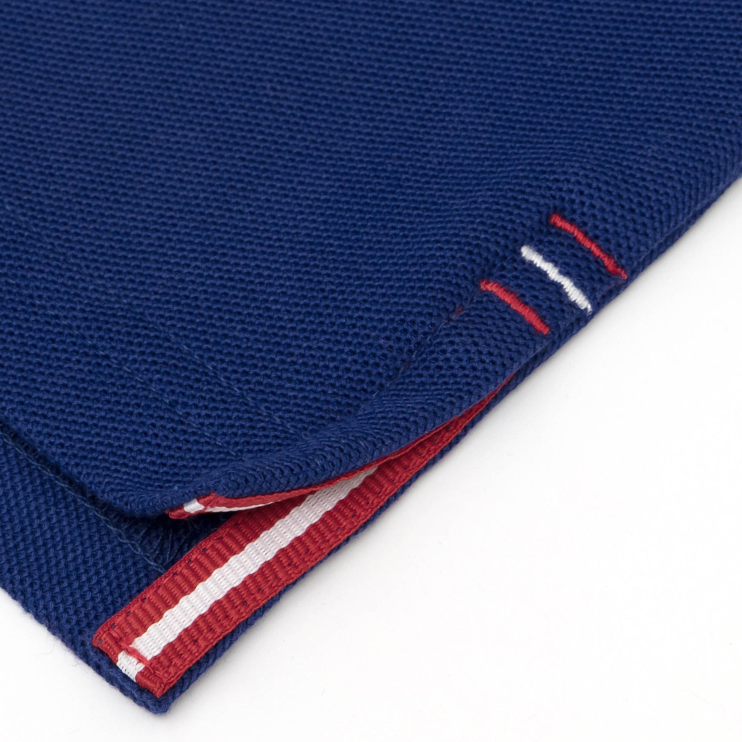 Red and white grosgrain detail on side vent.