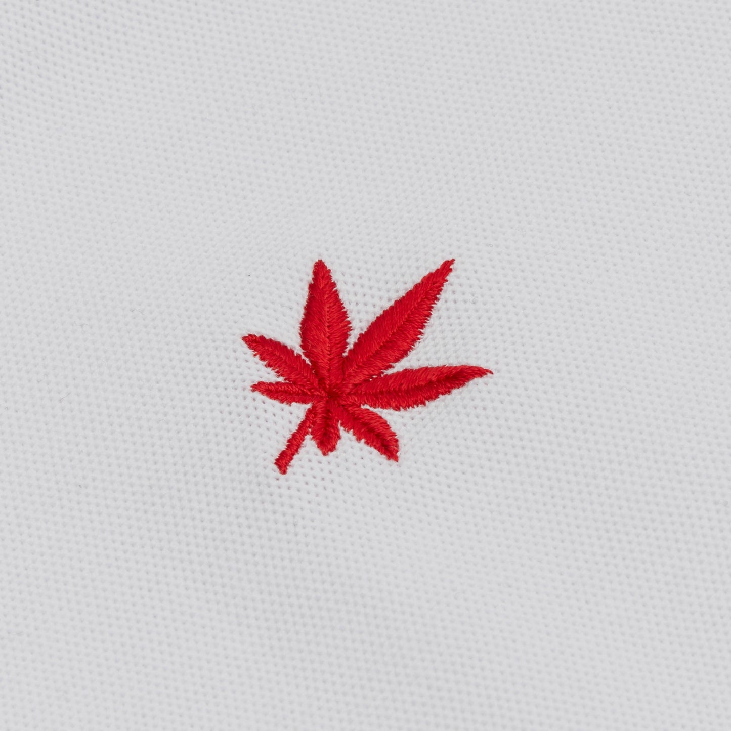 Red embroidered leaf.