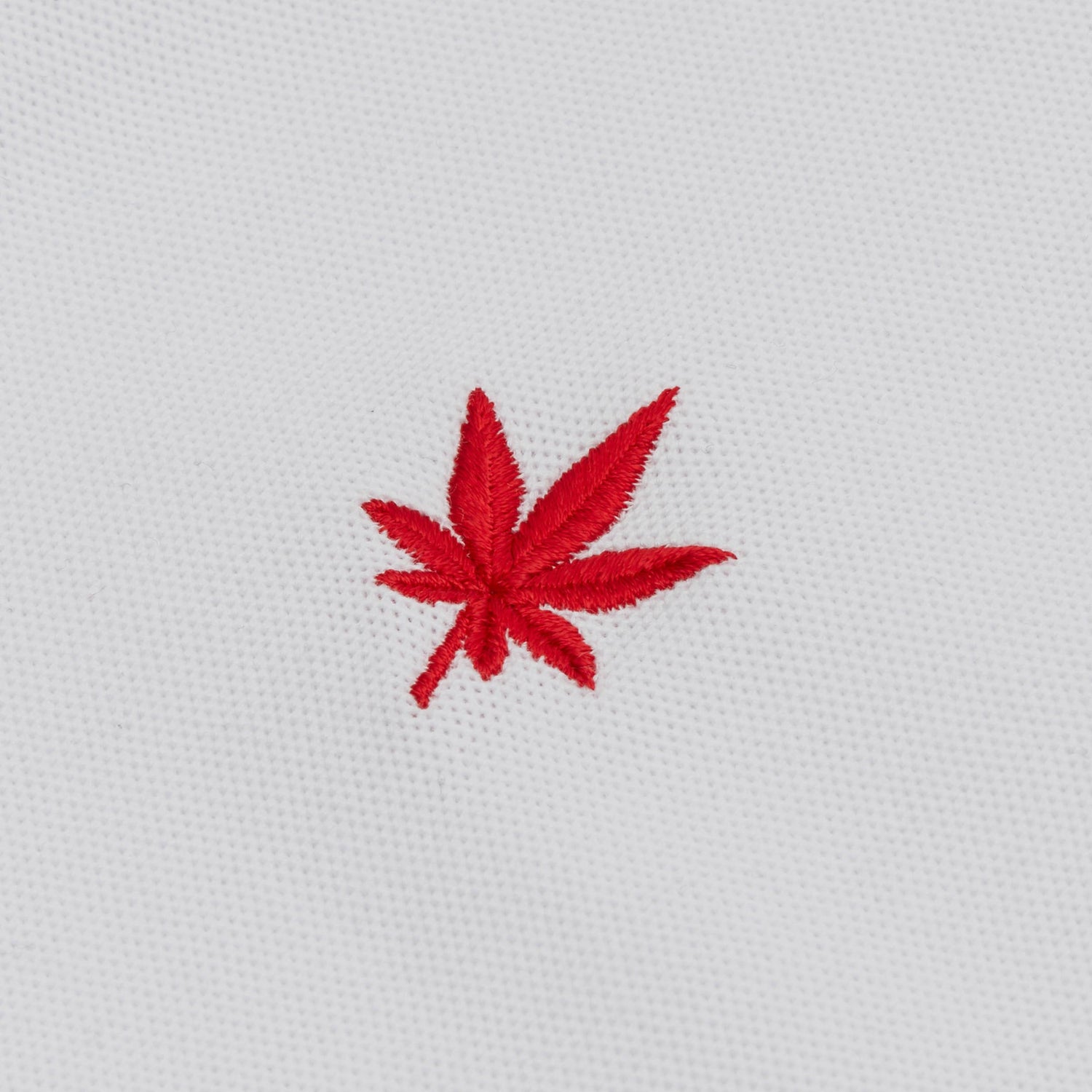 Red embroidered leaf.