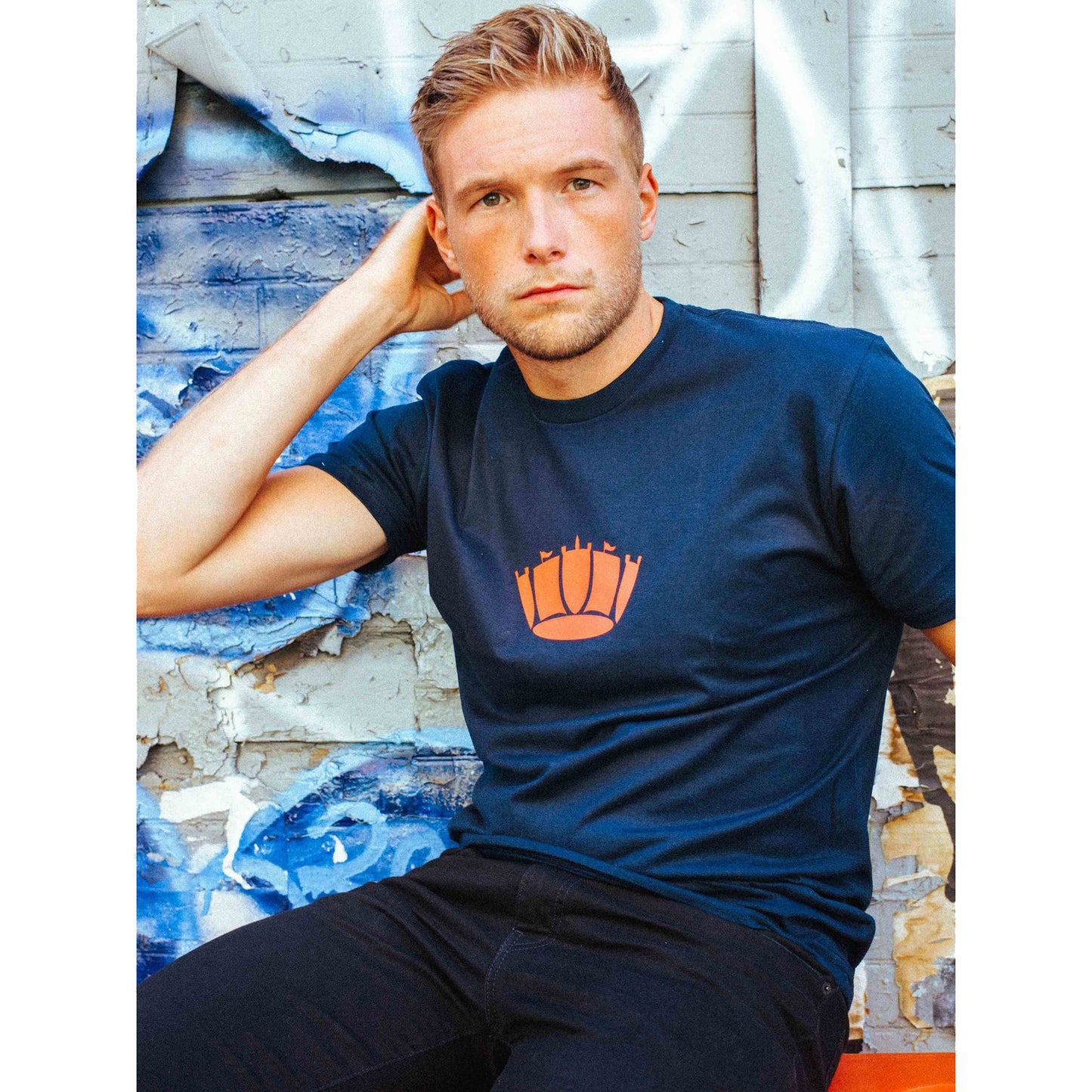 Male model wearing the Naval Crown Polo Tee.