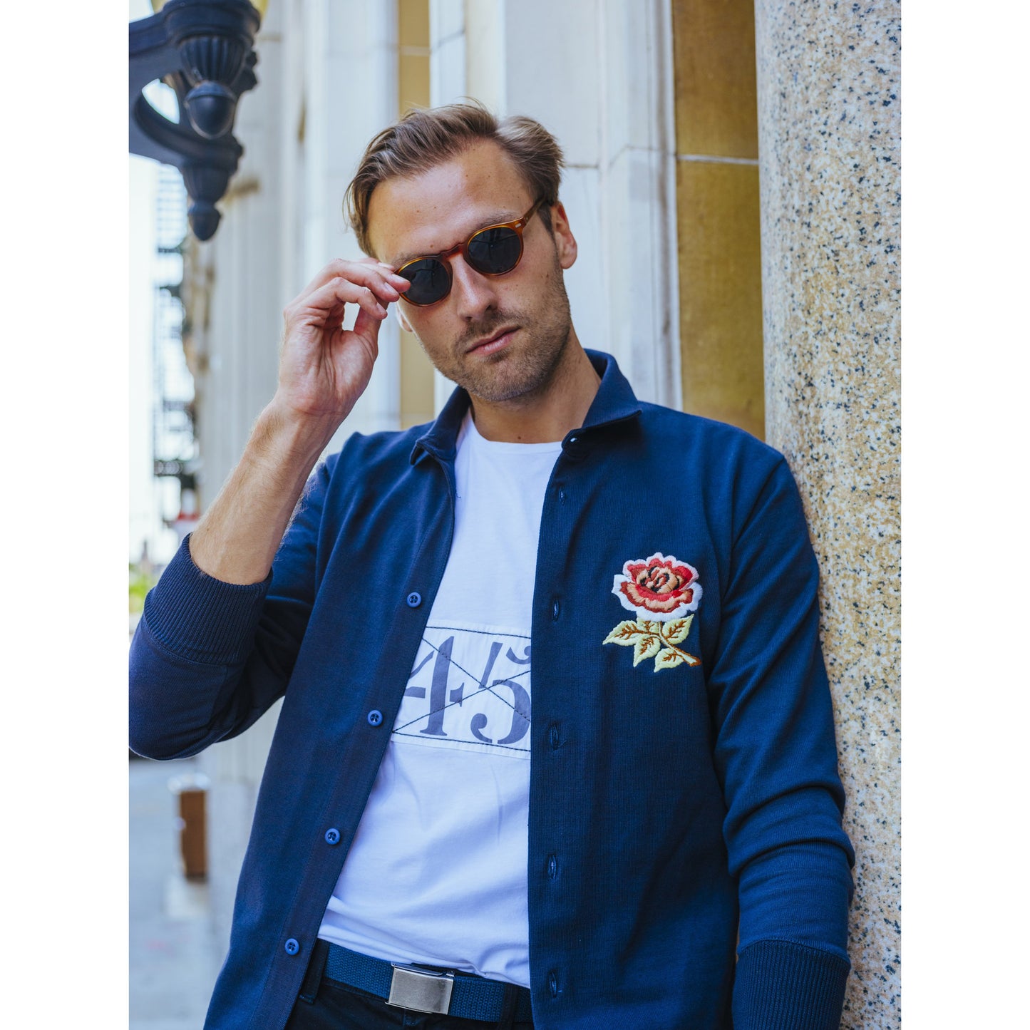 Male model wearing the England Rugby Overshirt unbuttoned over a t-shirt.