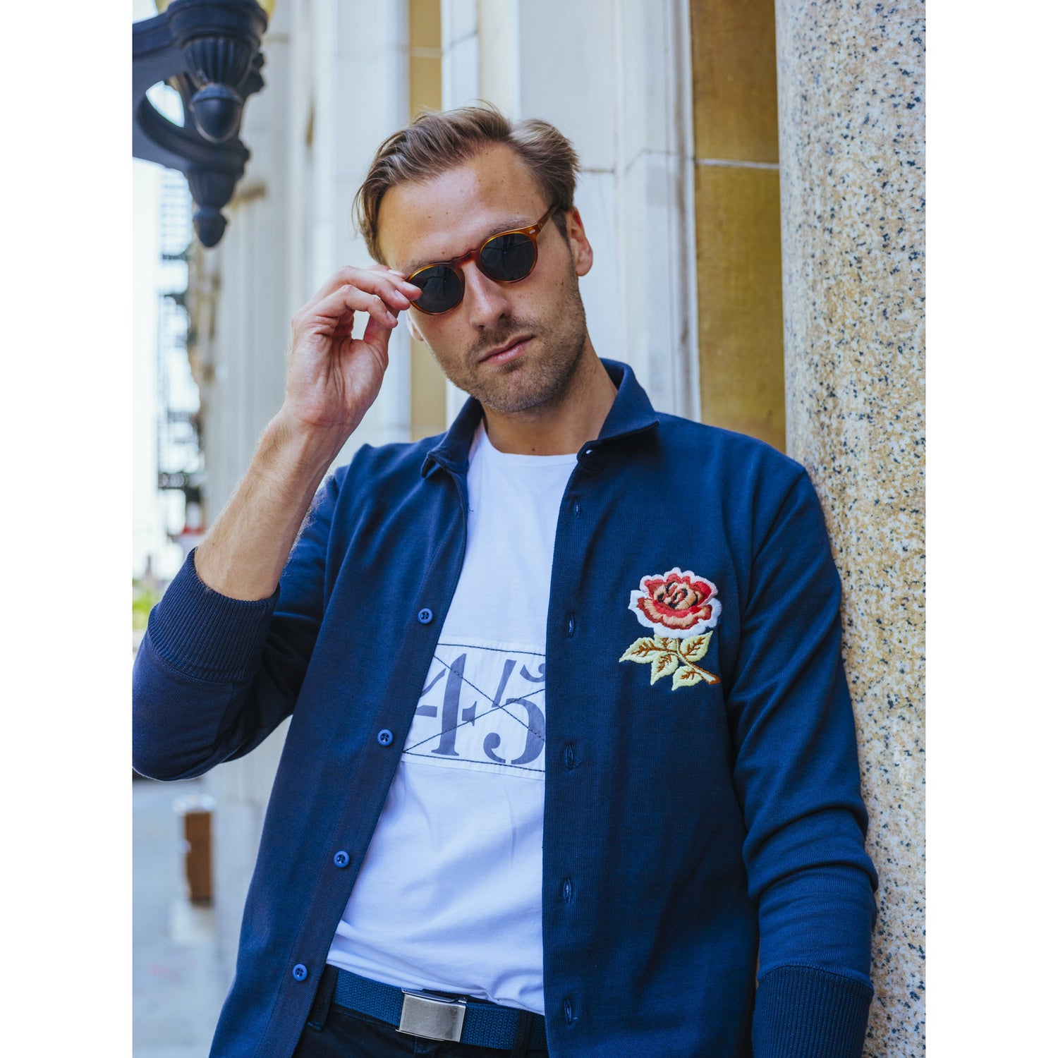 Male model wearing the England Rugby Overshirt unbuttoned over a t-shirt.