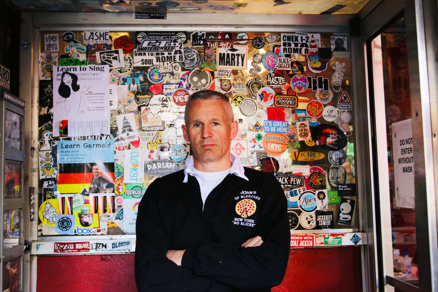 Man wearing the John's Pizza "No Slices" Rugby