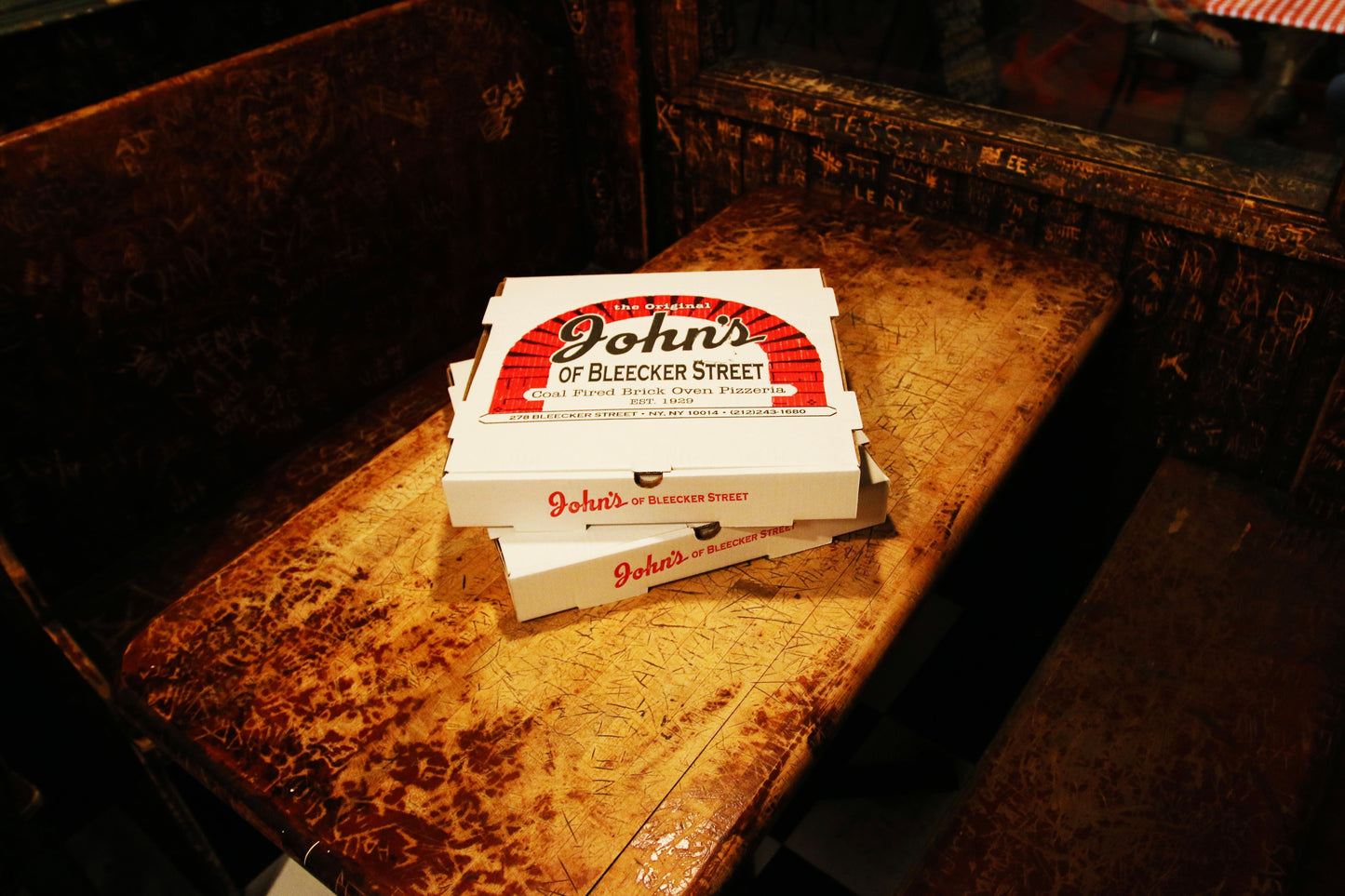Pizza Boxes on top of a table at the restaurant