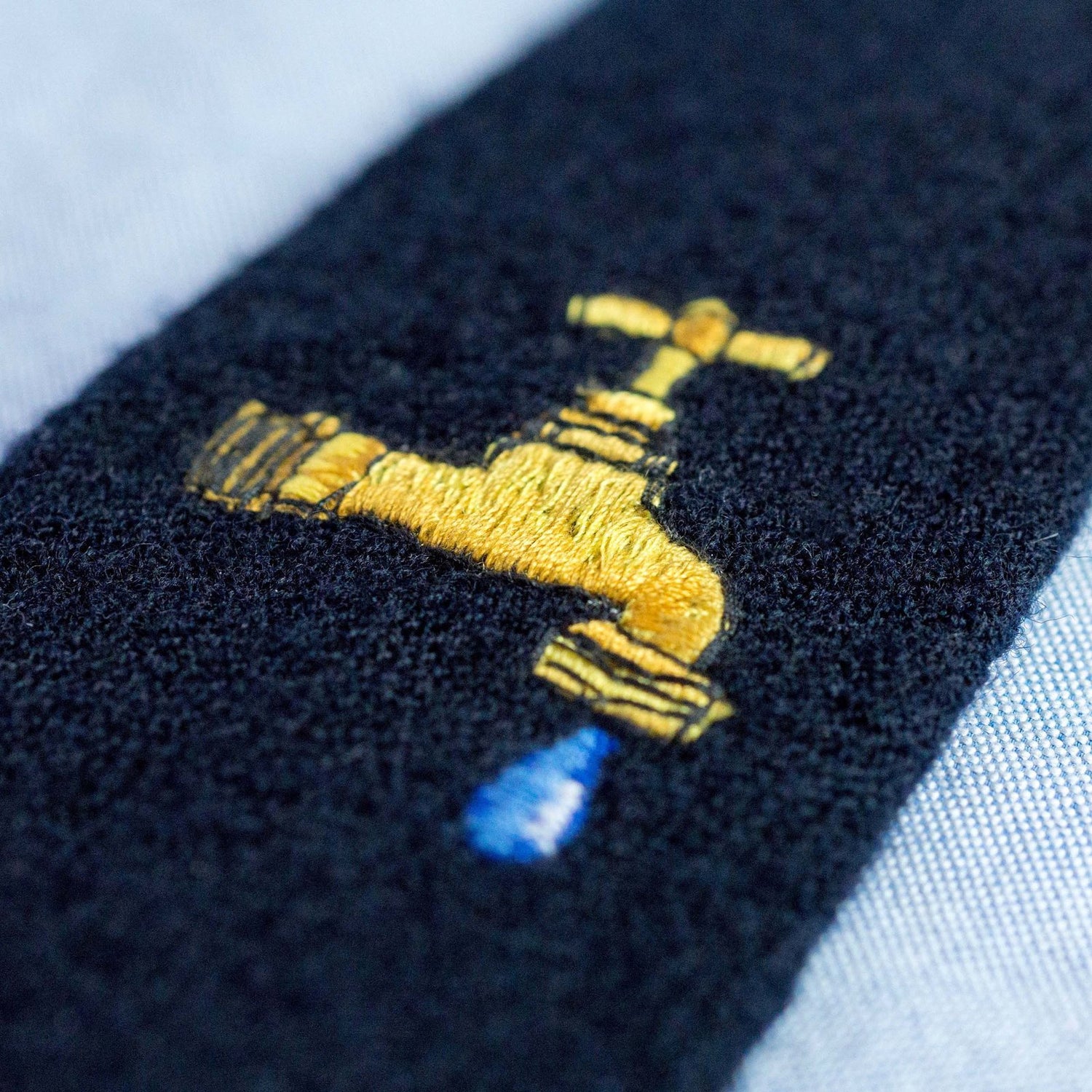 Embroidered faucet motif.