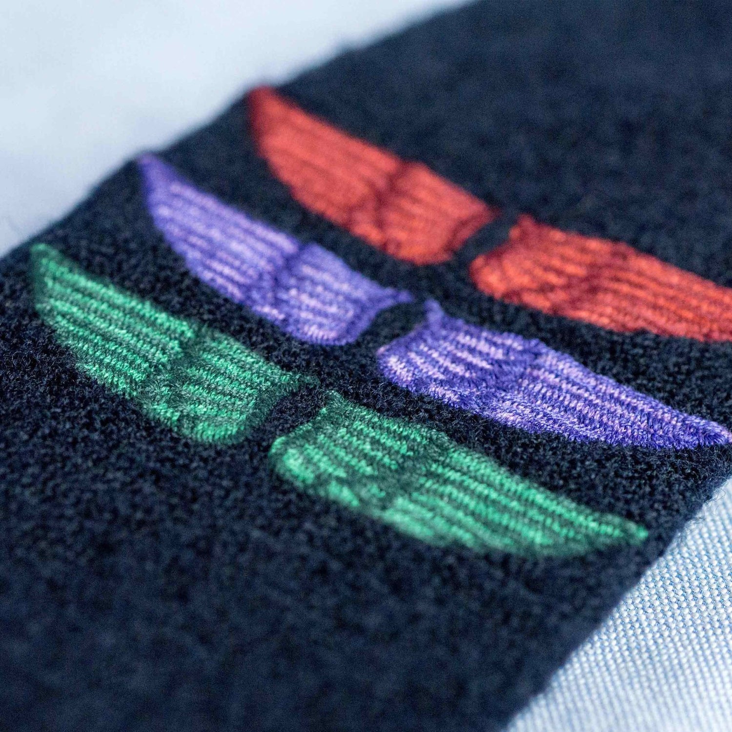 Embroidered biker wings motif.