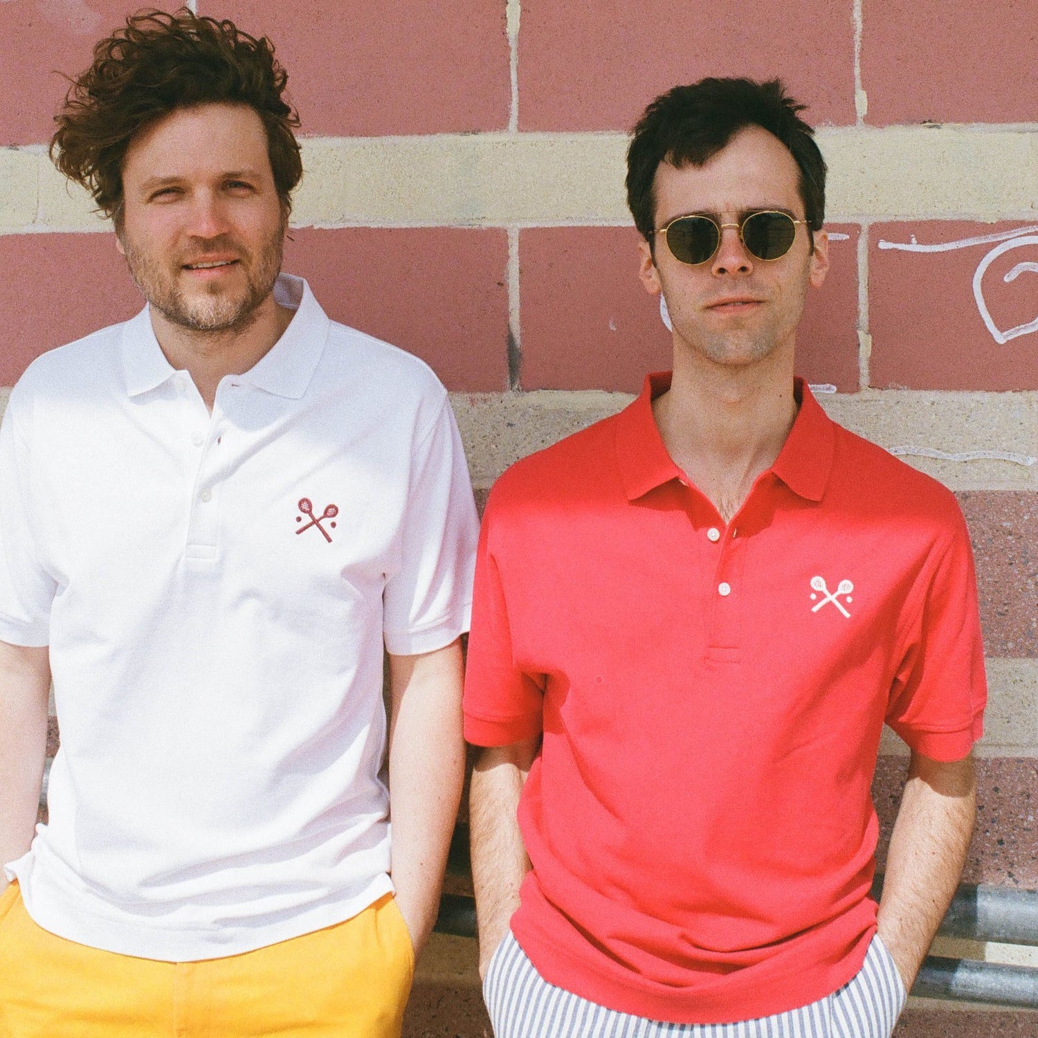 Models wearing the white and red Racquets Polo.