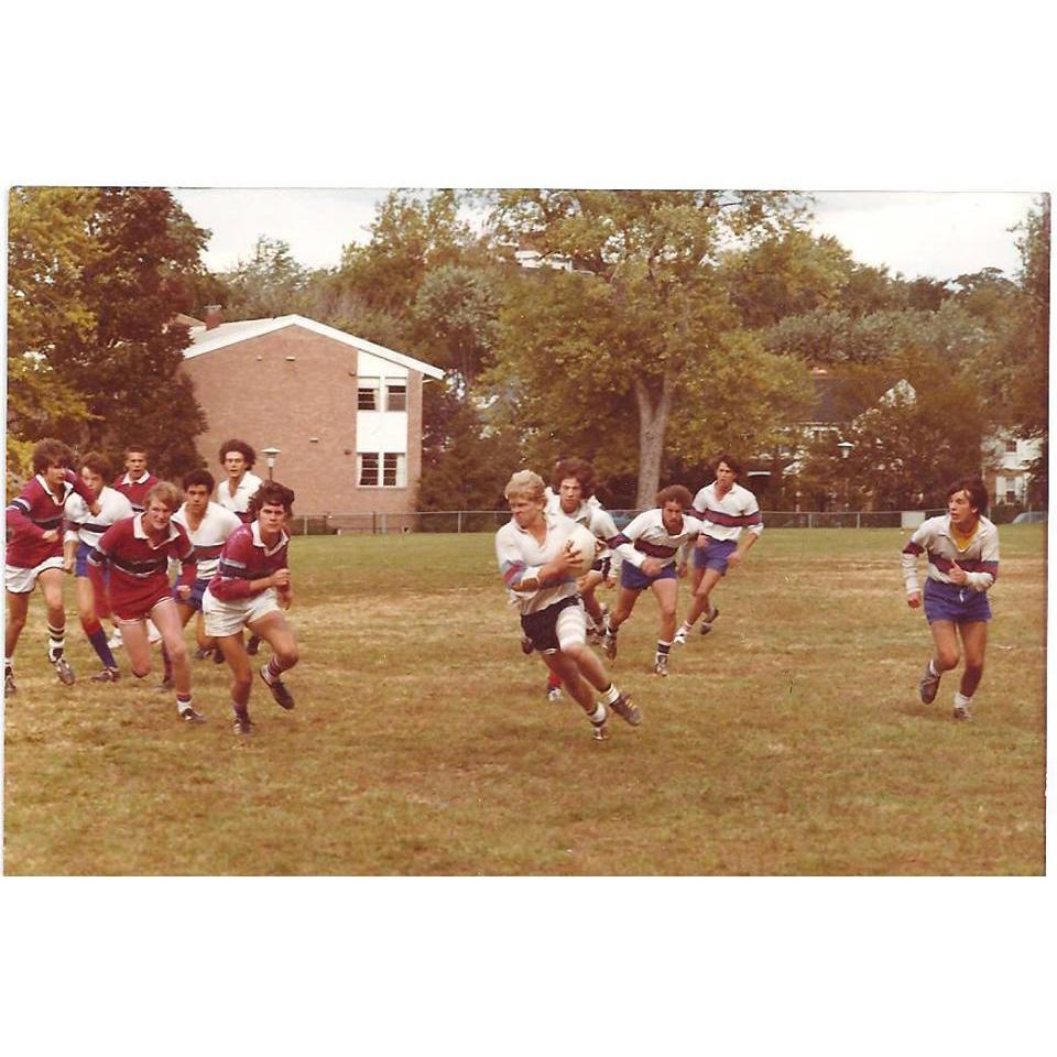 Old photo of young men playing rugby.