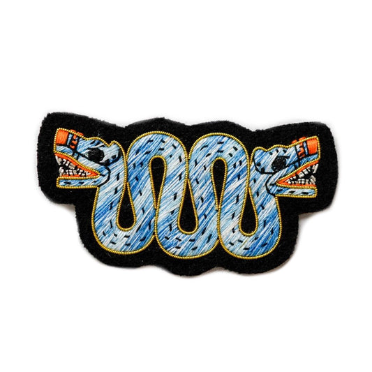 Hand embroidered patch of Aztec serpent.