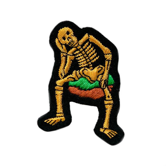 Hand-embroidered Derry bones skeleton badge.