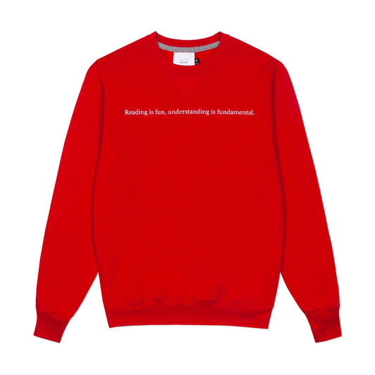 Red crewneck with "Reading is fun, understanding is fundamental." across the front.