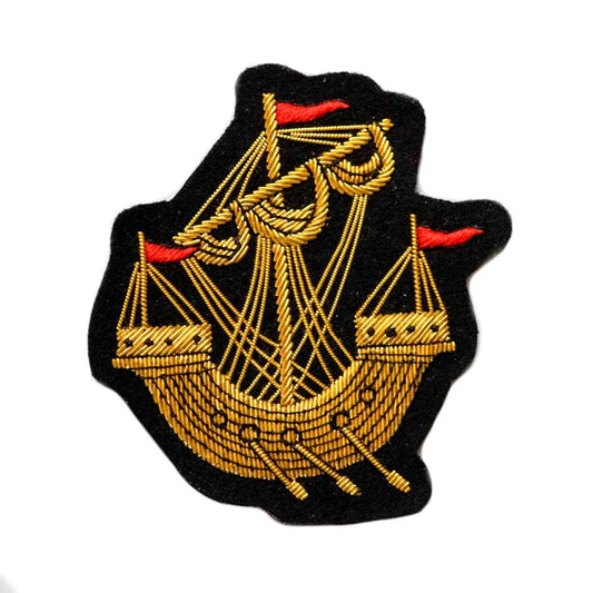 Hand-embroidered gold work Lymphad badge.