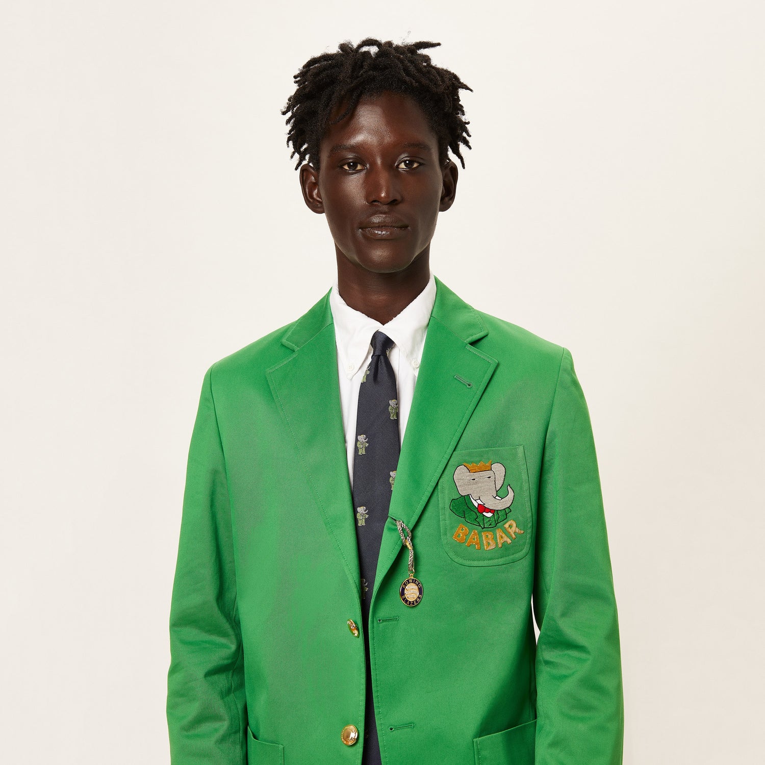 Male model wearing the Babar Suit Tie with a green suit.