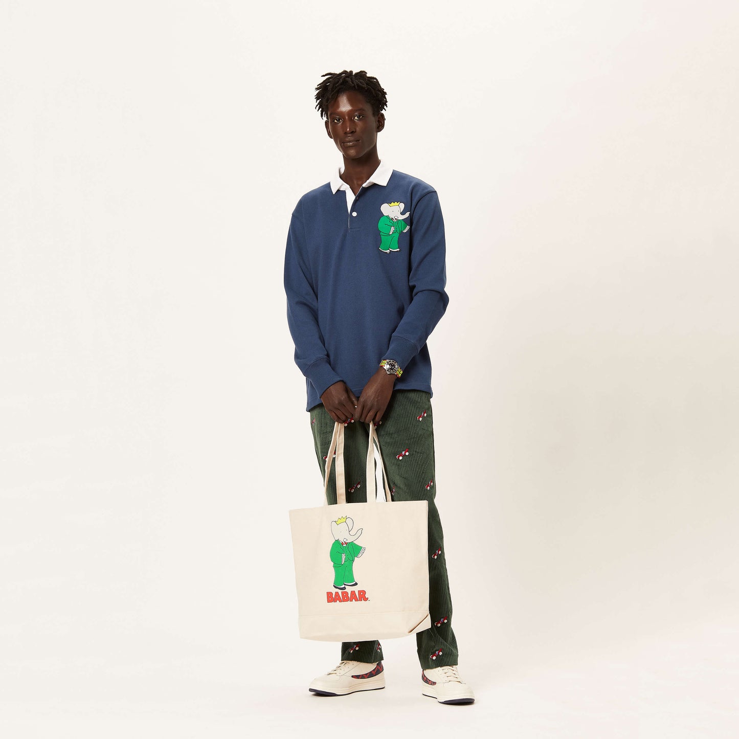 Male model holding the Babar Tote.
