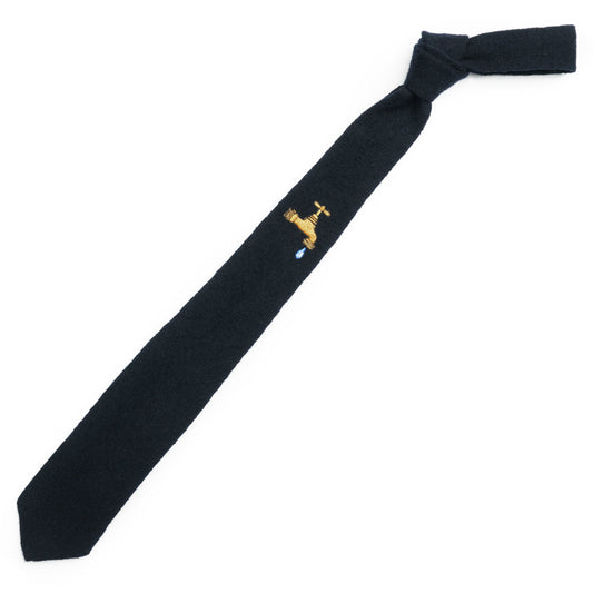 Navy tie with single embroidered faucet motif.