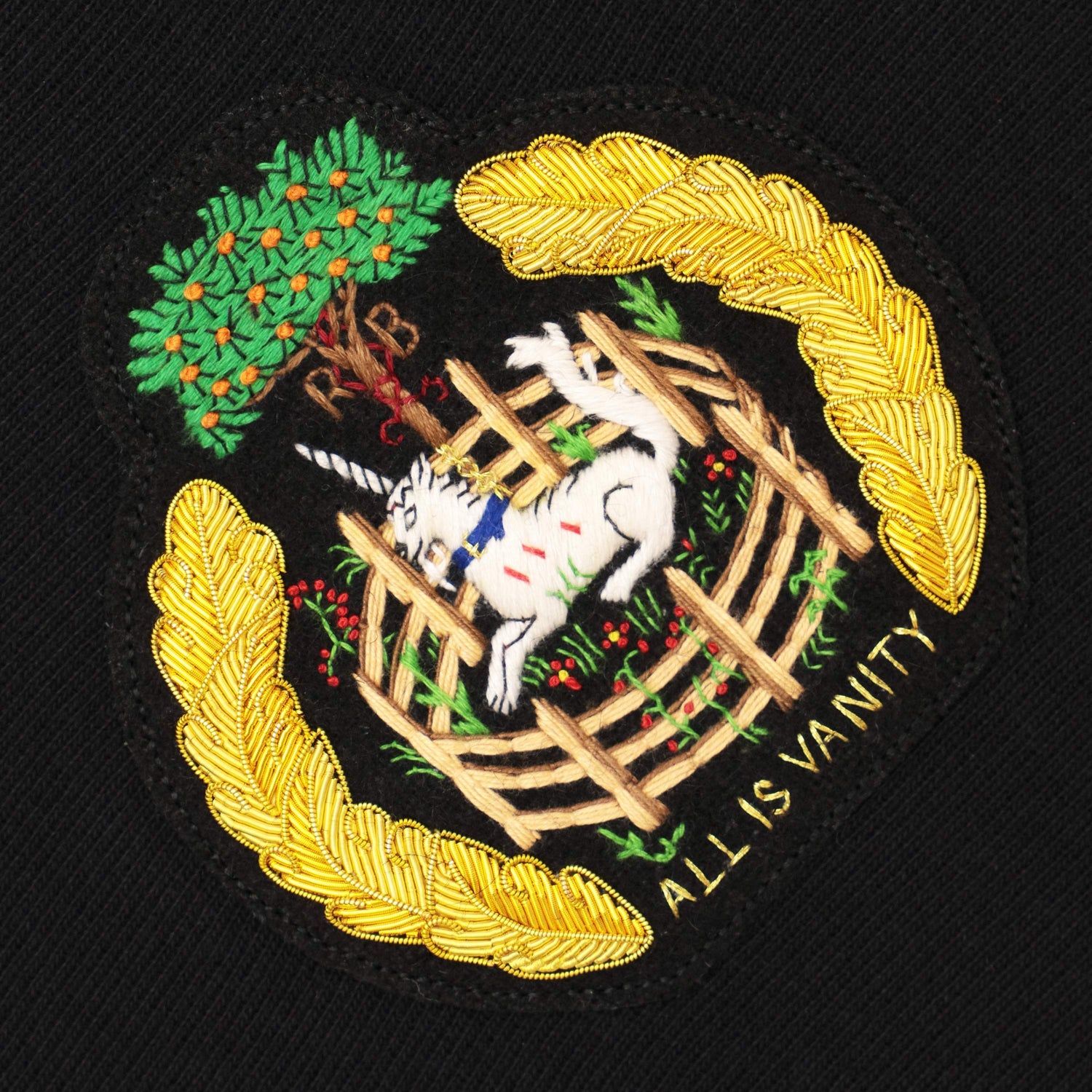 Goldwork unicorn motif and the words "All is Vanity."