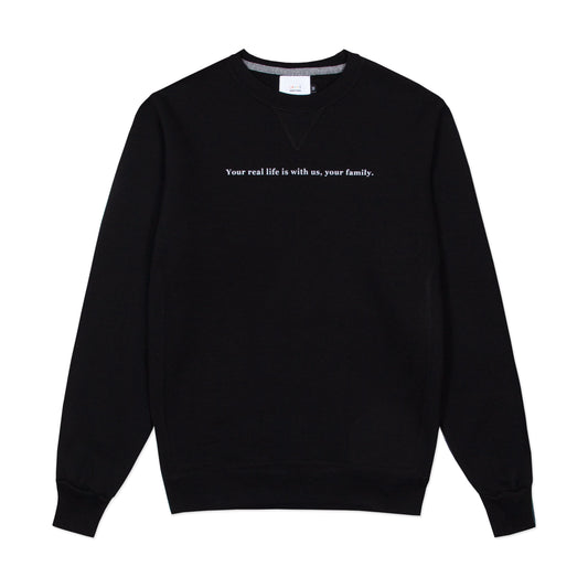 Black crewneck sweatshirt with "Your real life is with us, your family." on the front.