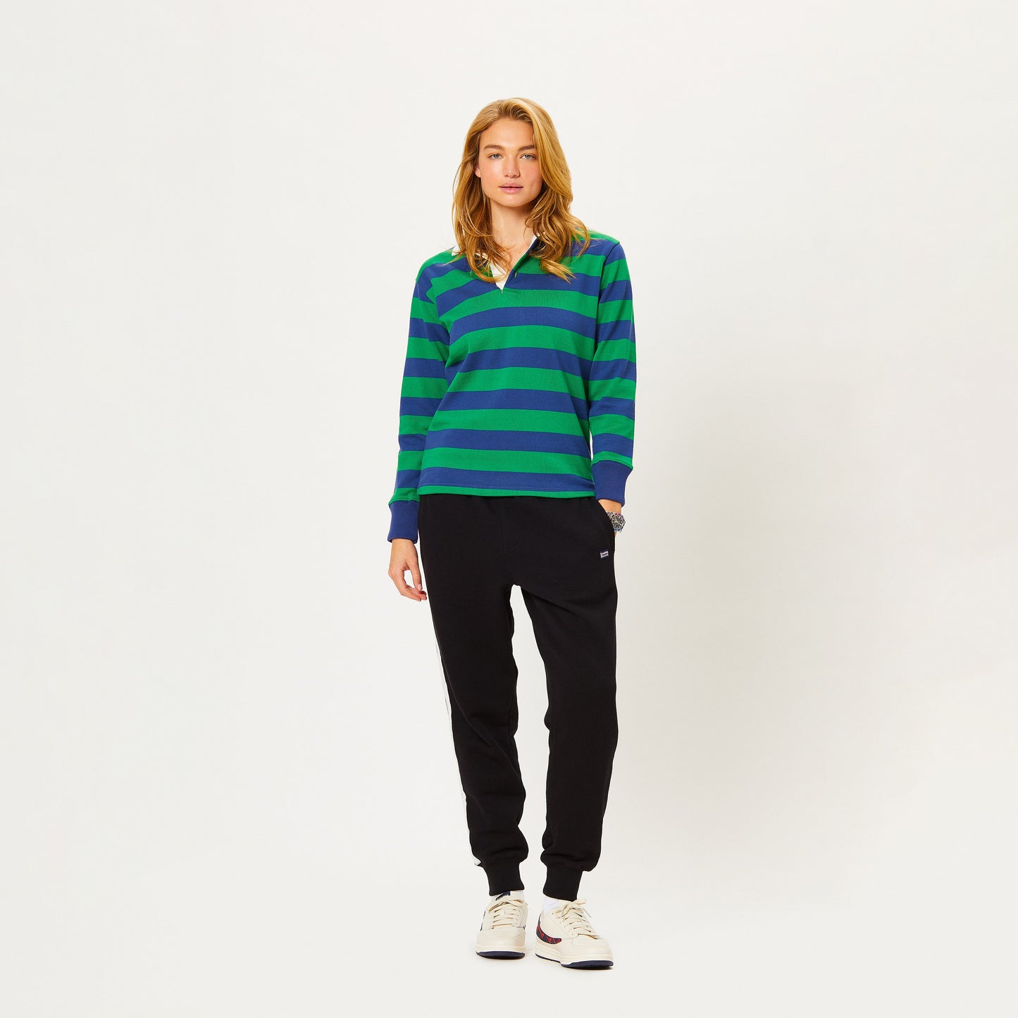 Female model wearing the Hockney Stripe Rugby in green and blue.