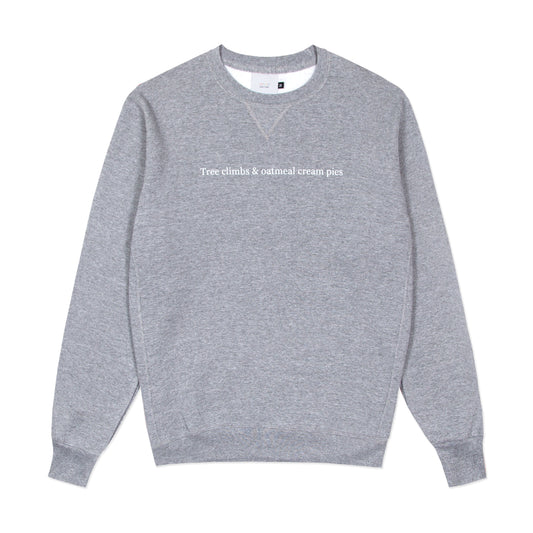 Grey crewneck sweatshirt with "Tree climbs & oatmeal pies" printed across the chest.