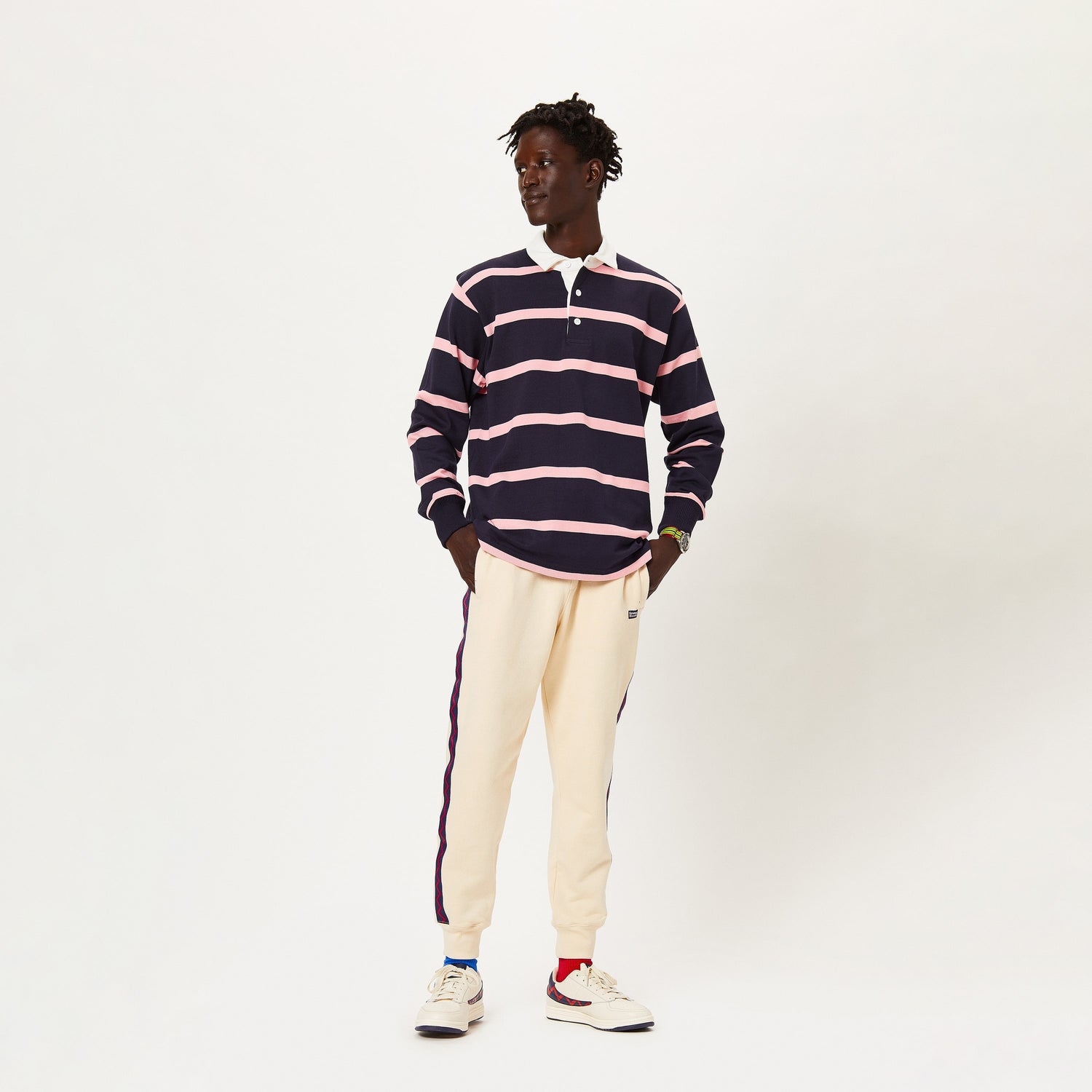 Male model wearing the Hockney Stripe Rugby in navy and pink.