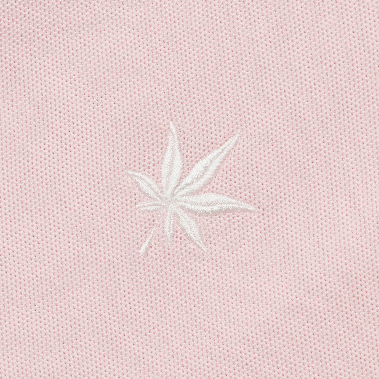White embroidered leaf.