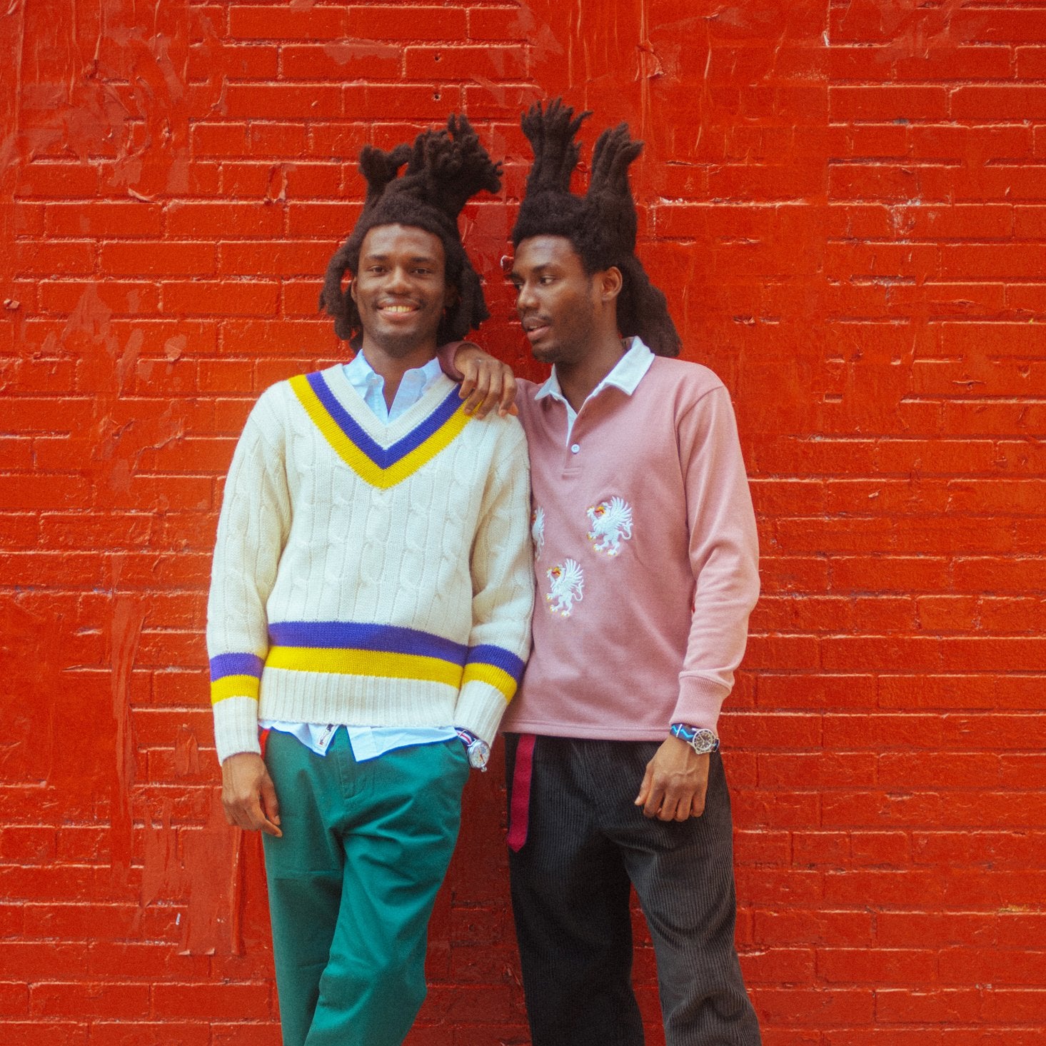 Twin male models, one wearing the Cream Wool Cricket Sweater in the Purple and Yellow colorway.